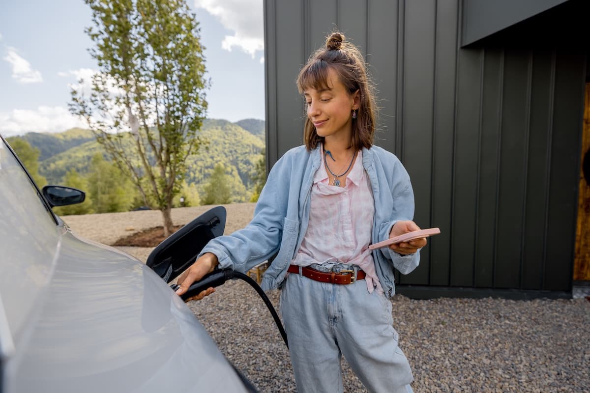 A driver charging her EV at home